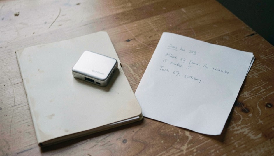 Documentary photograph of a small external drive, a restored blank folder and a handwritten test sheet turned away, no legible writing, clear morning light. Distinct lead composition for this editorial entry.